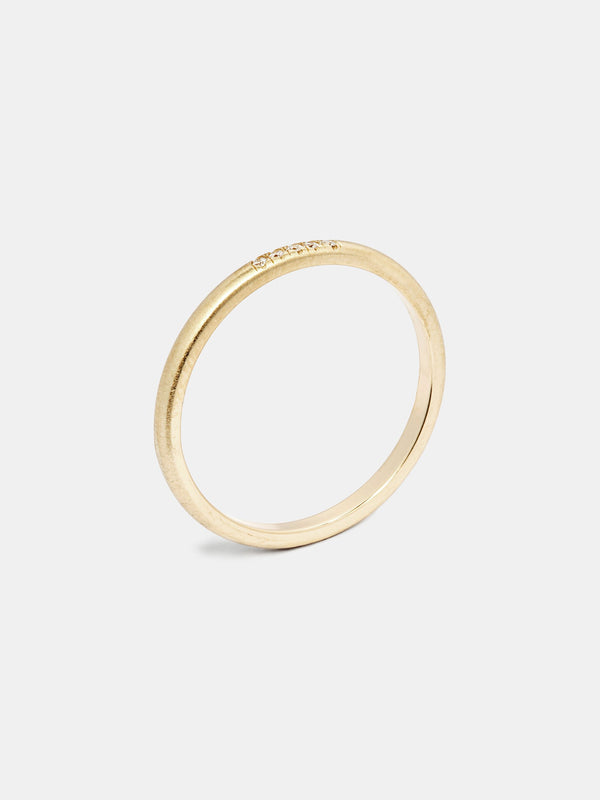 Anise Band in 14k yellow gold with five 1mm recycled diamonds and signature matte finish.
