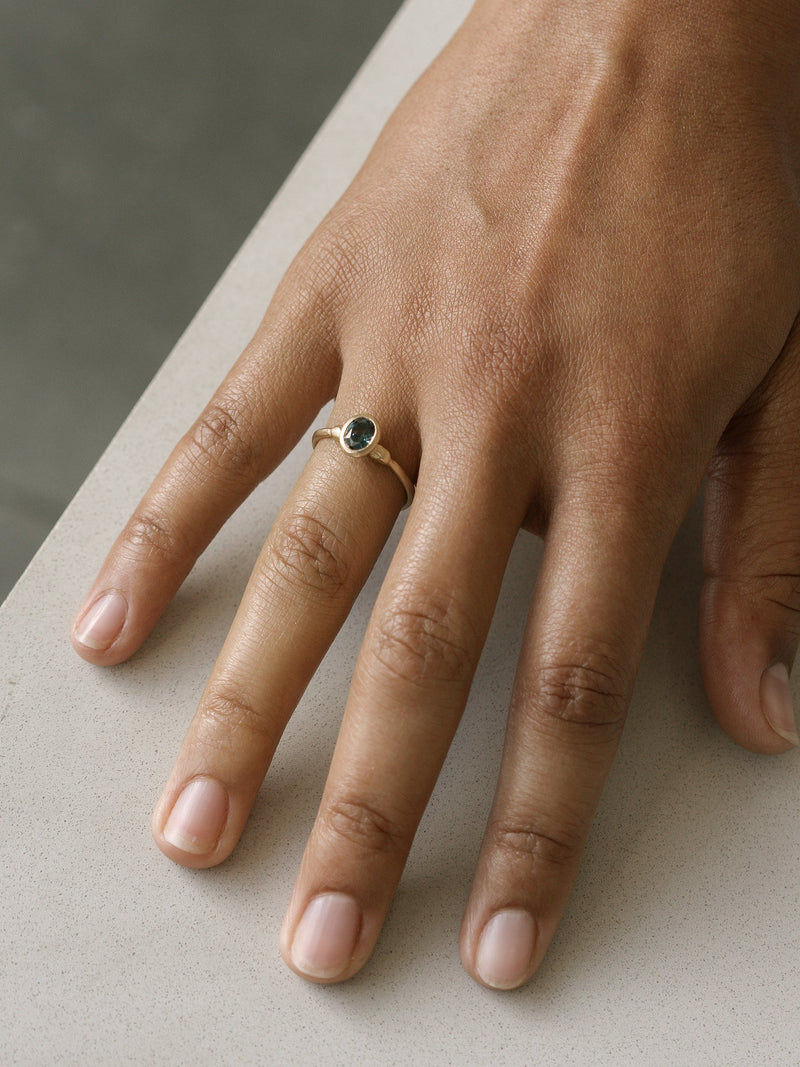 Shown: 0.75ct teal Montana sapphire in 14k yellow gold with organic texture and signature matte finish. 
