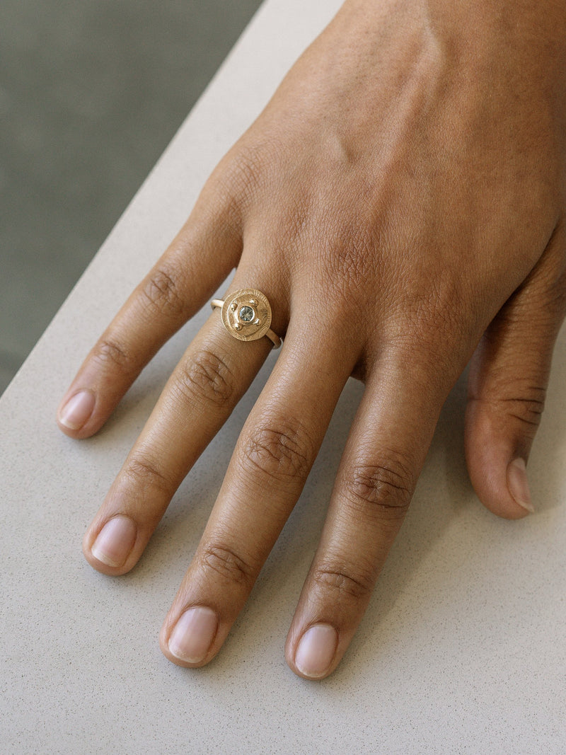 Shown: 0.25ct mint Montana sapphire in 14k yellow gold with organic texture and signature matte finish.