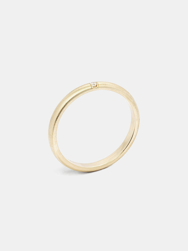 Luna Band in 14k yellow gold with one 1.5mm recycled diamond and smooth texture with signature matte finish.