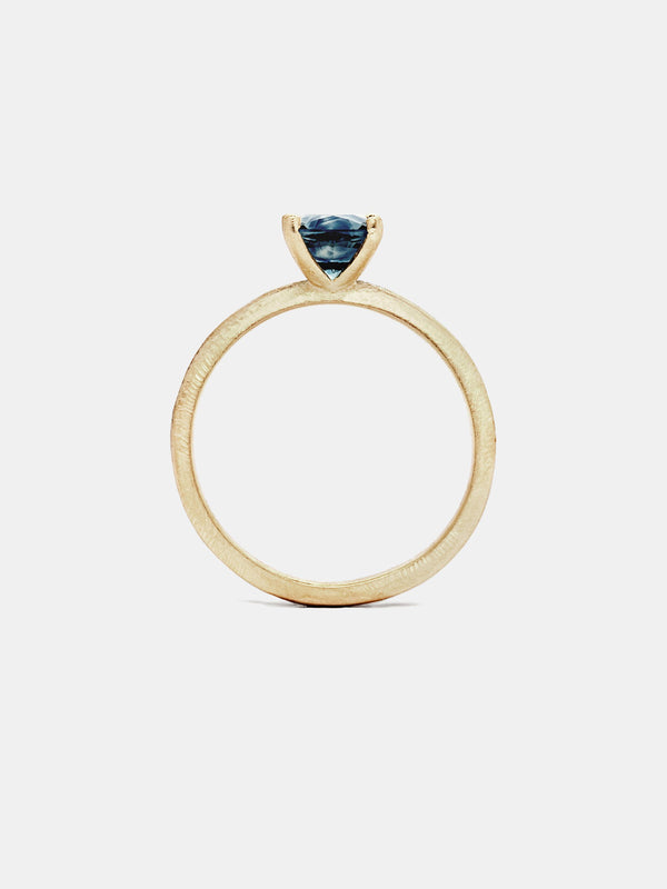 Sage Cushion Solitaire- Sapphire with 1ct teal Montana sapphire in 14k yellow gold with organic texture and signature matte finish. 